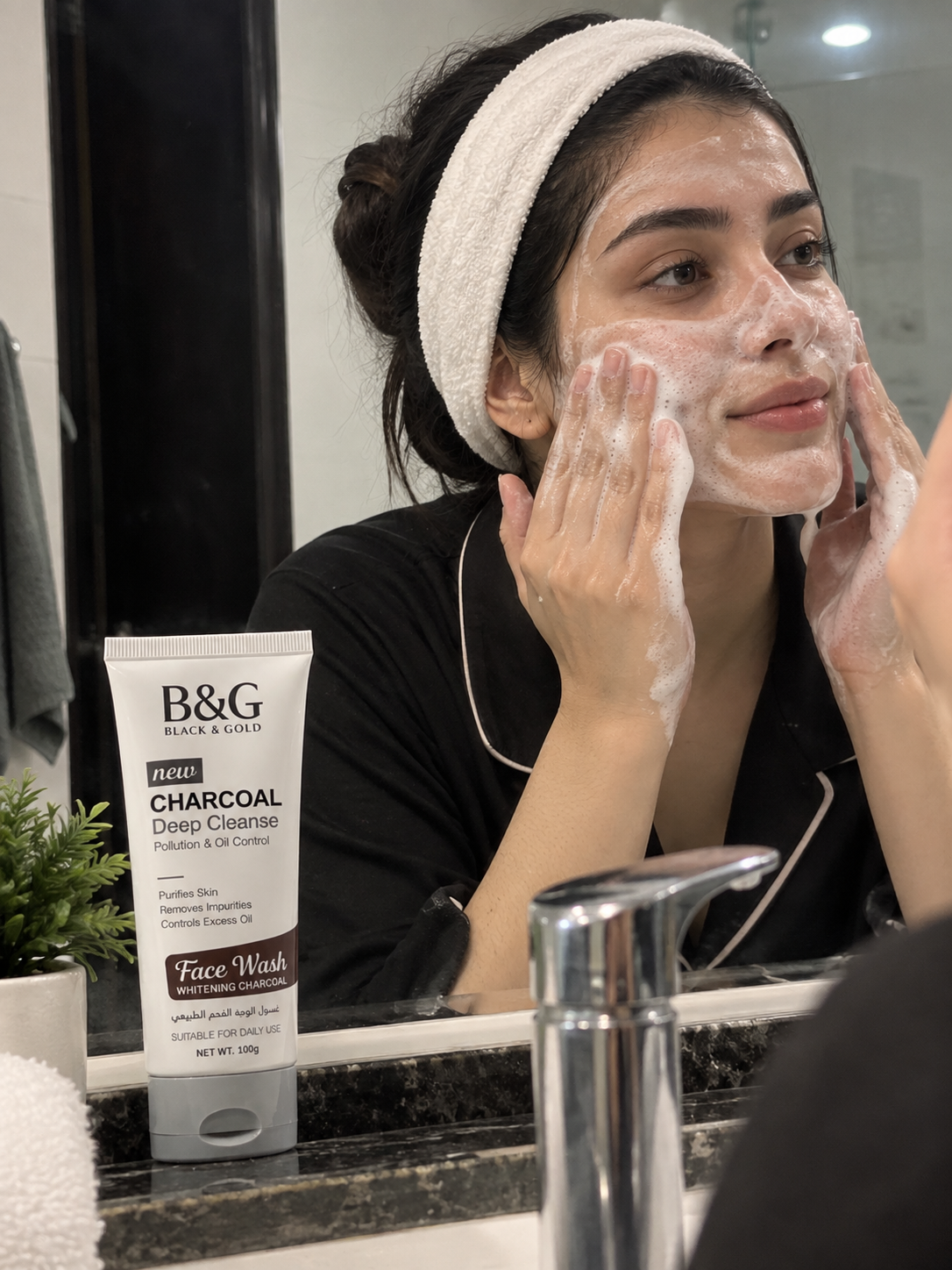 Woman applying B&G Black & Gold Charcoal Deep Cleanse Face Wash during her skincare routine