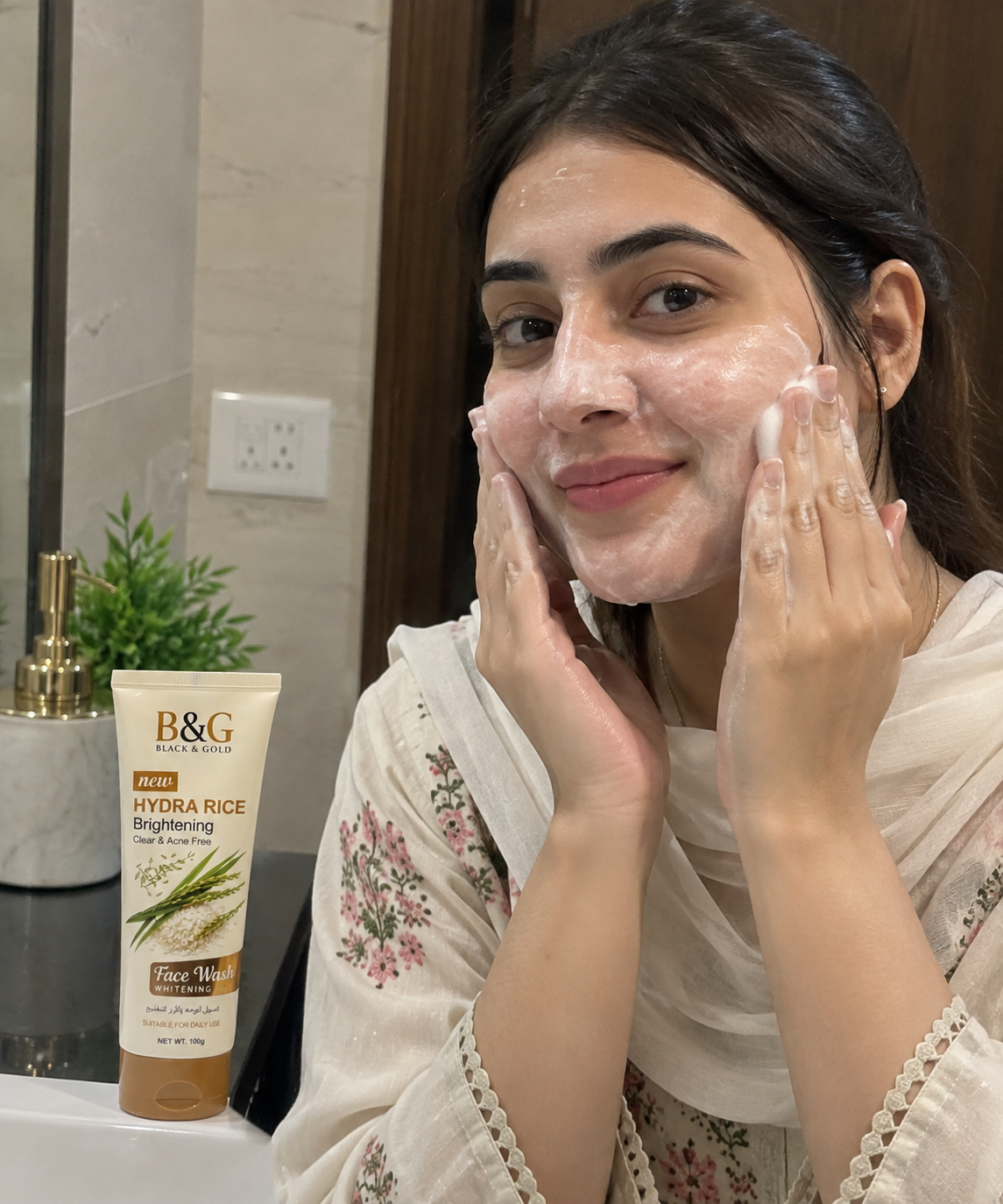 Pakistani woman applying B&G Black & Gold Hydra Rice Brightening Face Wash to her face